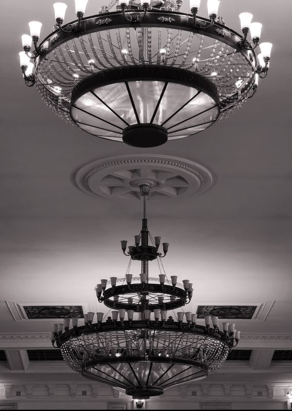 A classic chandelier under a decorative ceiling rose